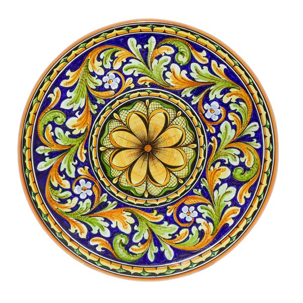 Decorative wall plate in polychrome Caltagirone majolica with a flower in the center