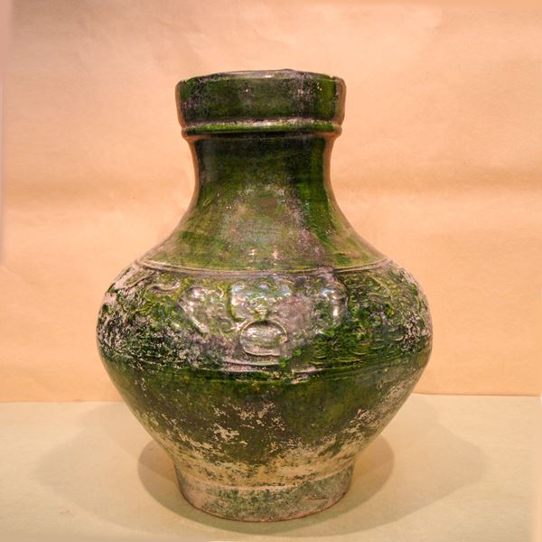 Green vase decorated with animals in relief