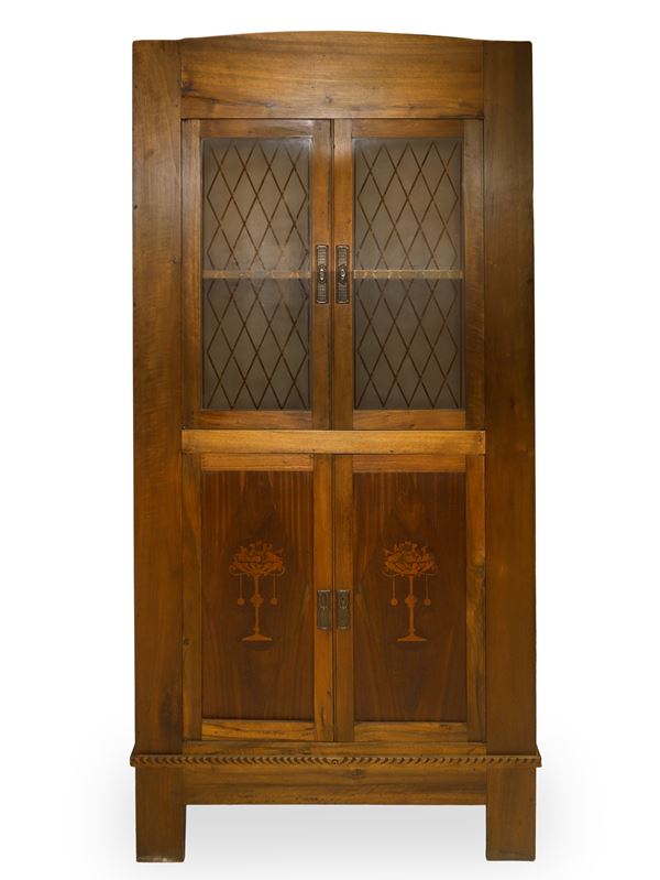 Large wooden corner cabinet with upper glass doors and decorated lower doors