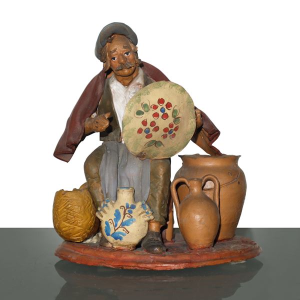Potter, painted clay figurine