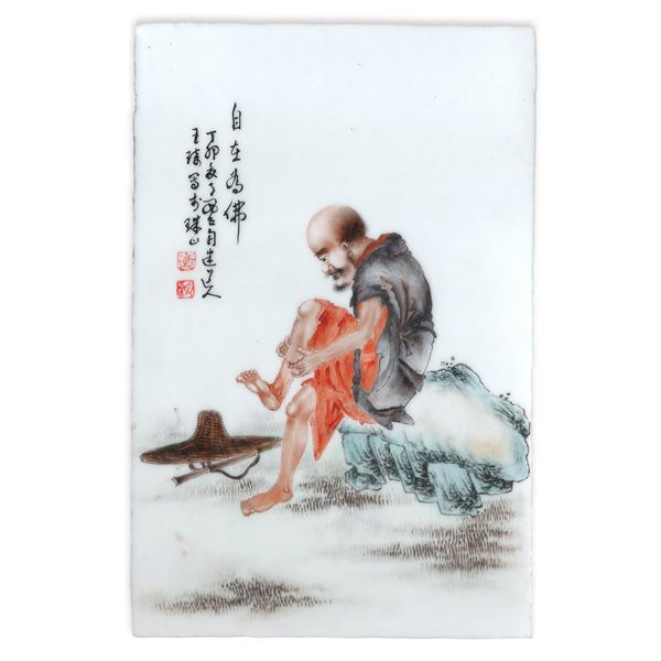 Painted porcelain plaque depicting a man at rest
