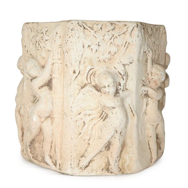 Octagonal plaster vase decorated with cherubs in relief along the entire body of the vase and an inscription on one of the sides 