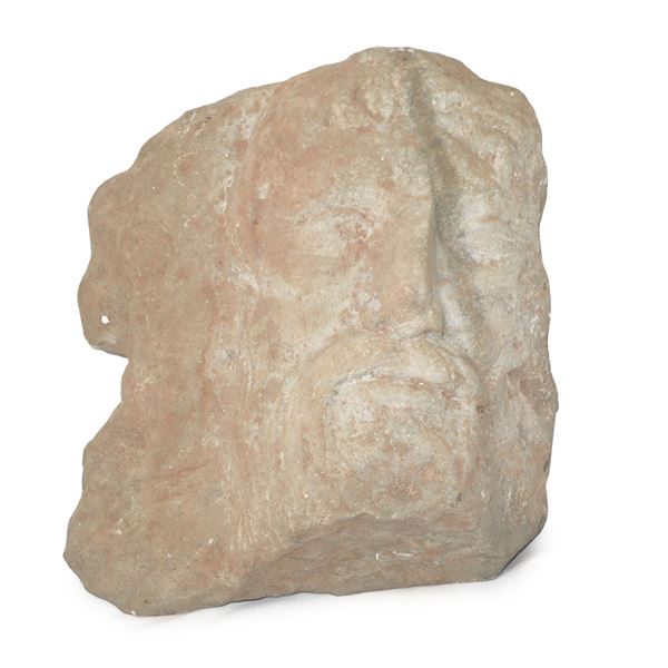 Fragment depicting a male face in high relief in marble 