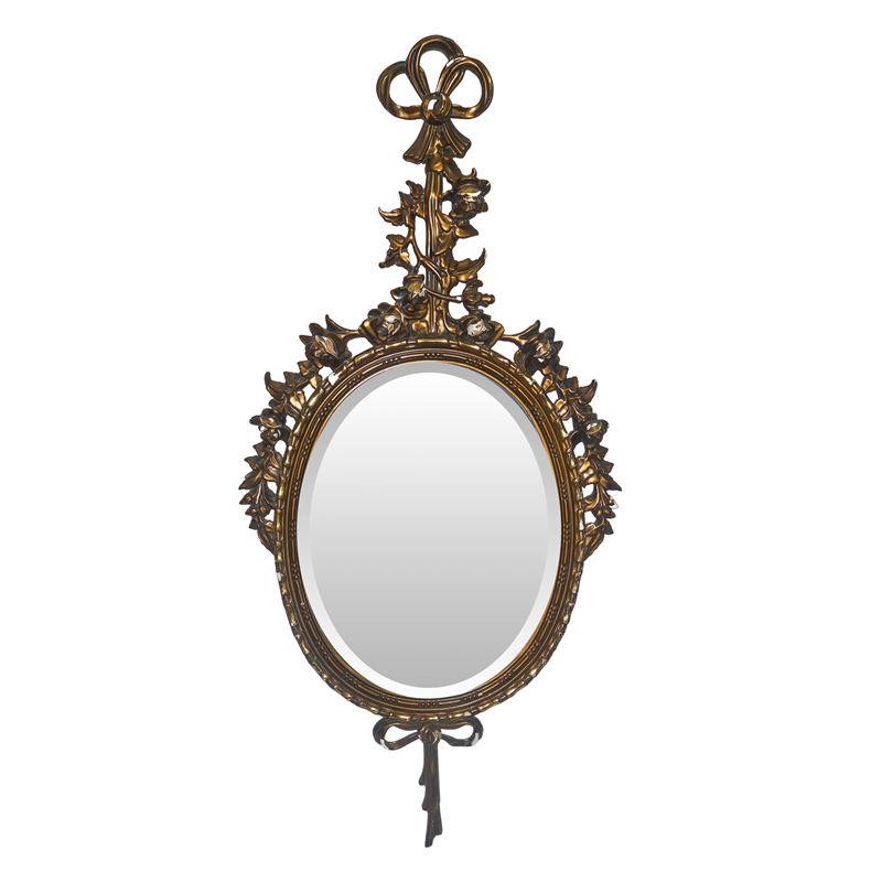 Specchiera ovale entro cornice dorata con decori floreali e fiocchi pendenti alla sommità e alla ...