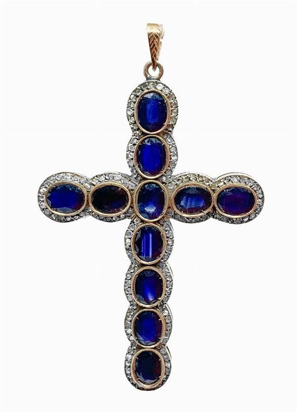 Cross in gold and silver with sapphires. Gr 15.5