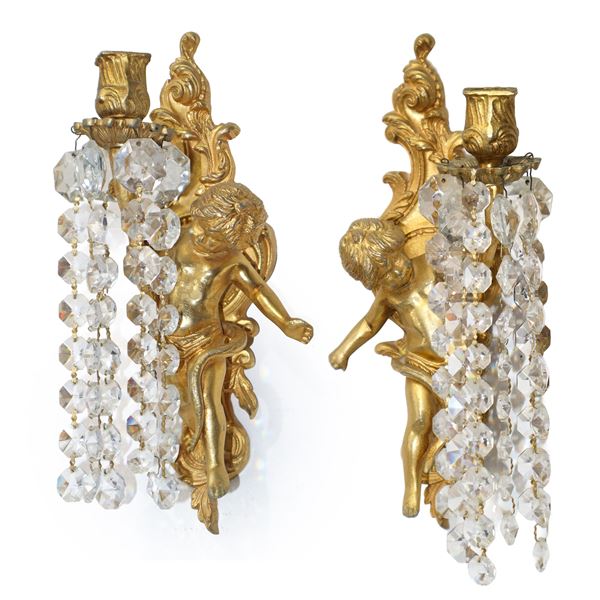 Pair of single-light gilded wall lamps in the shape of a cherub