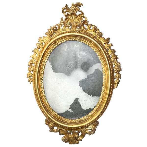 Oval mirror with frame and gilded and carved wood with cymatium