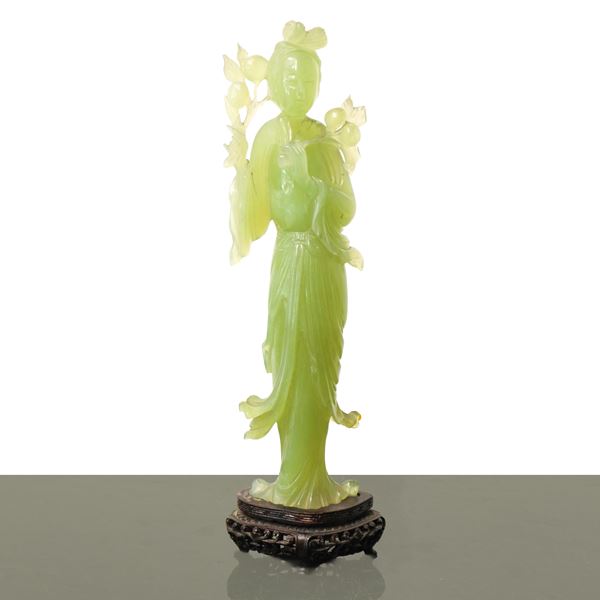 Green jade Guanin on a wooden base
