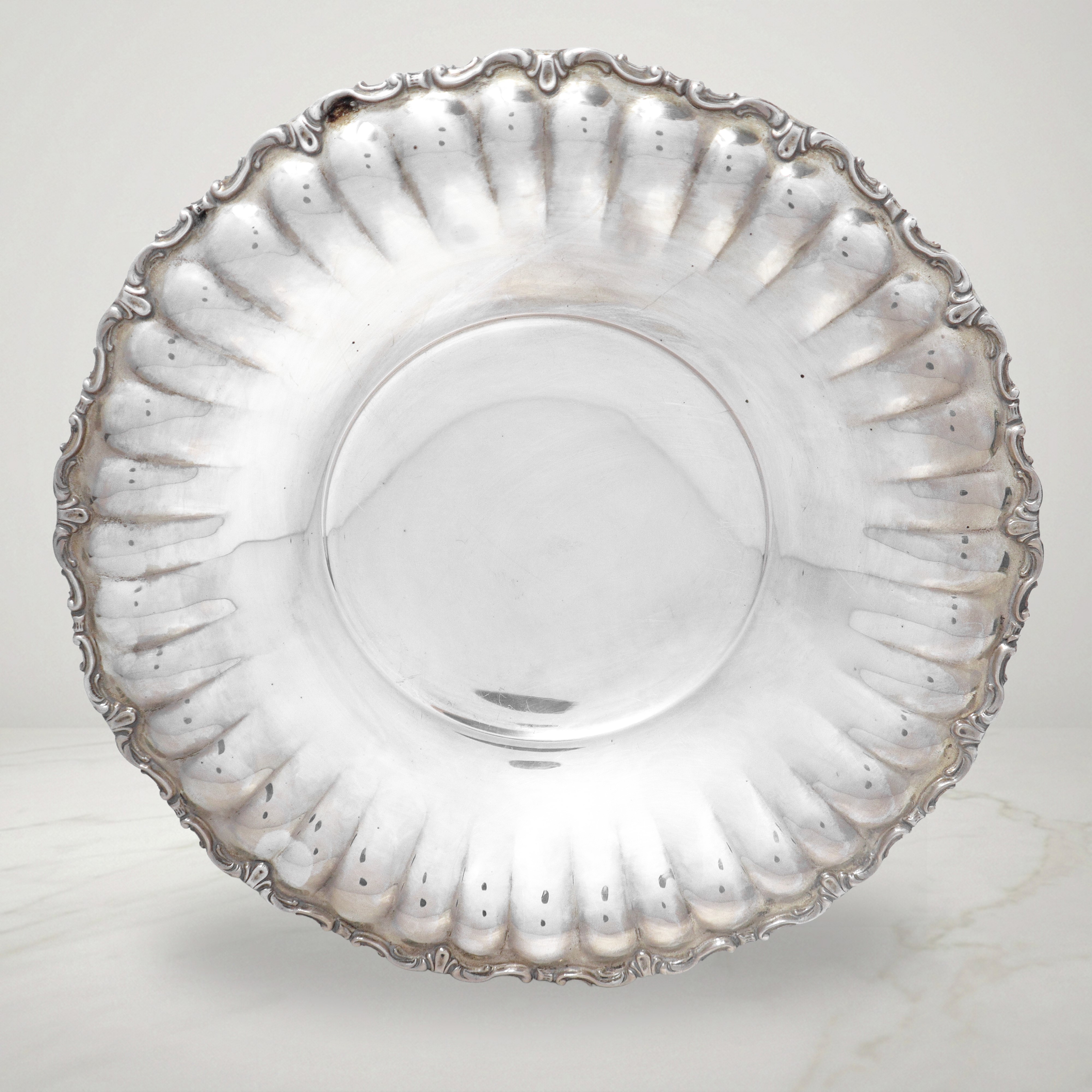 Coppia di piatti alzate in argento 800 con bordi decorati a volute