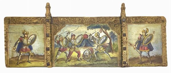 Sicilian cart "sponda" with polychrome depictions in three sections, Sicily, early nineteenth century. Great battle between the Paladins and Saracens with carvings of angels and grotesque with dragons, eagles and floral 108 x 43 cm