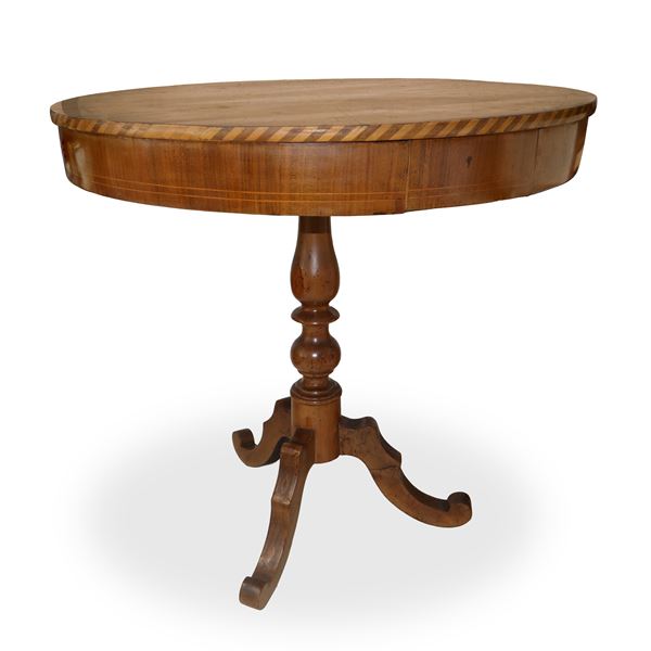 Three-legged circular table in walnut with star inlay