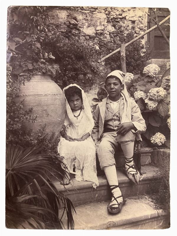 Wilhelm von Gloeden (1856-1931), albumin photos depicting couple of kids in costume Sicilian villa. hallmarked on the back. Cm 17x22

"Wilhelm Von Gloeden was a German-born photographer who spent most of his life in Sicily, specifically in Taormina, a city that he chose as a second home. It was the youth health issues to take in the peninsula. Specifically, the choice of Taormina is linked dreamy ideal of Sicily that the photographer releases in his pictures through the choice of models dresse