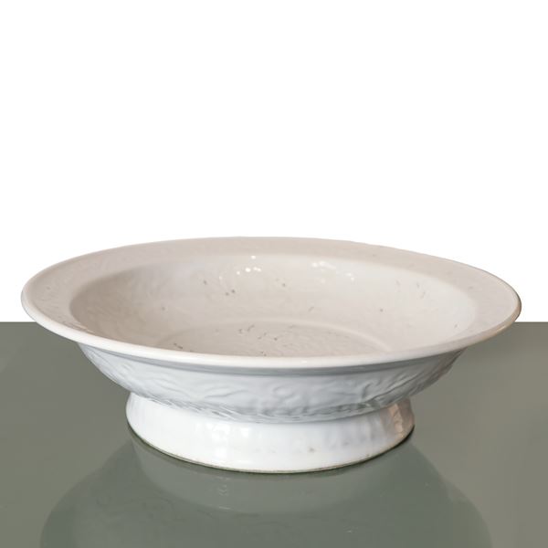 Large white enamelled Chinese porcelain plate with engraved and embossed floral and dragon decorations