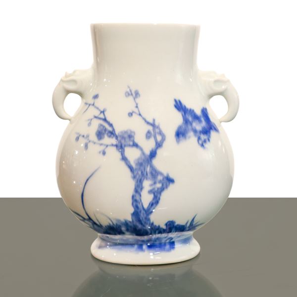 Blue and white Chinese porcelain vase with animal-shaped handles with floral decoration on the front and inscription on the back