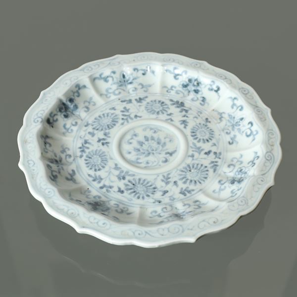 Blue and white Chinese porcelain plate decorated with floral motifs and scalloped edge
