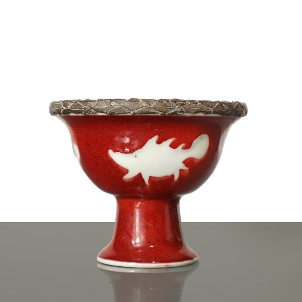 Small oxblood red Chinese porcelain cup/stand with fish decoration and metal rim