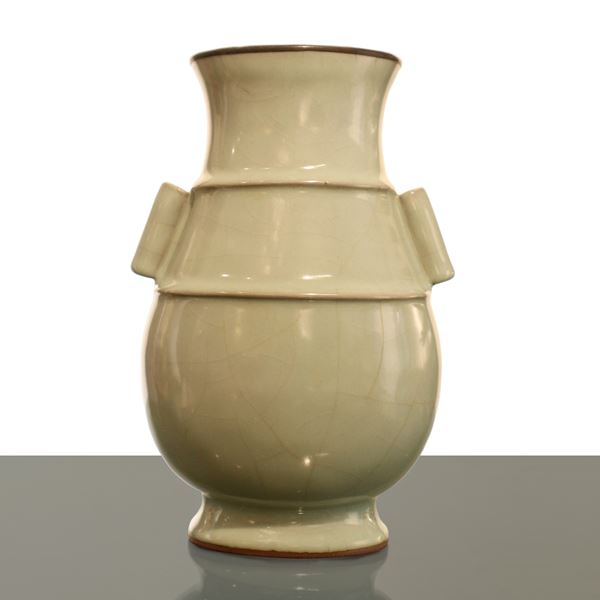 Chinese porcelain vase with two handles and a celadon glaze coating, the upper edge of the opening is finished with a metal coating.