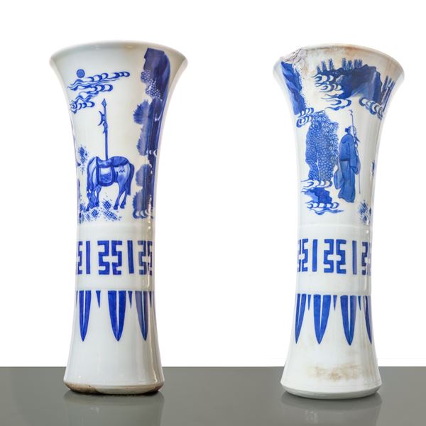 A pair of blue and white Chinese porcelain goblet vases decorated with scenes from Chinese history.