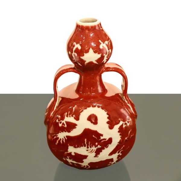 Oxblood red Chinese porcelain bottle with dragon decoration