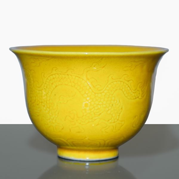 Small yellow glazed Chinese porcelain cup with tone-on-tone engraved decoration