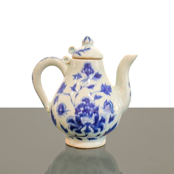 Antique blue and white porcelain teapot with floral decorations