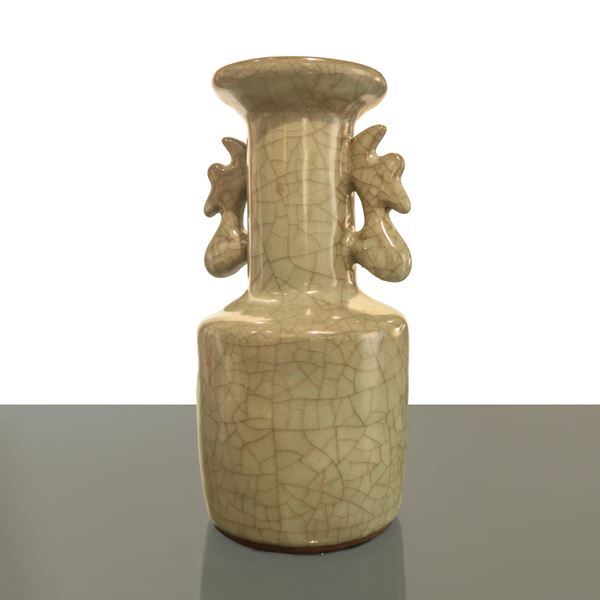 A two-handled Chinese porcelain vase covered with celadon glaze.