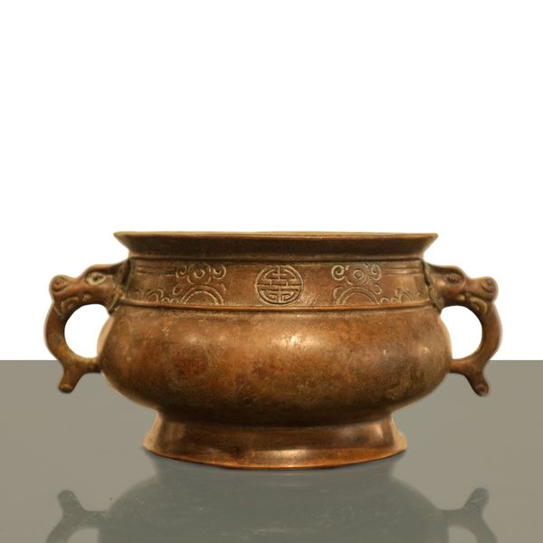 Bronze incense burner with animal-shaped handles and engraved edge