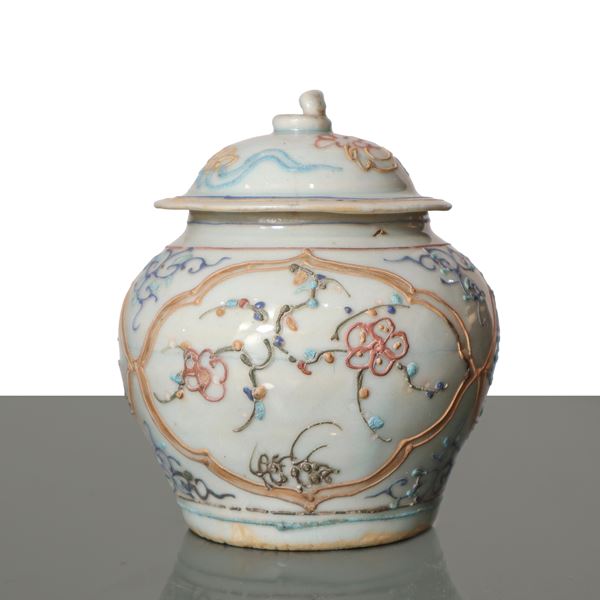 Small white Chinese porcelain vase with relief decorations in polychrome enamels