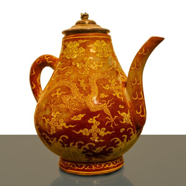 Red Chinese porcelain teapot with decorative dragon motif