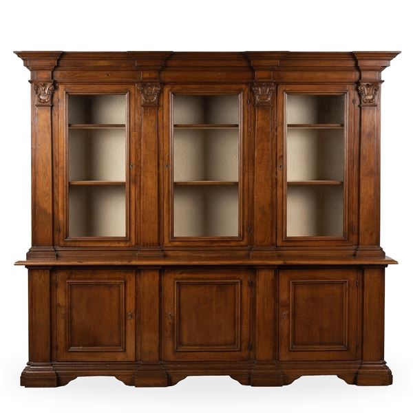 Bookcase with 3 wooden doors in the lower part and three transparent glass doors in the upper part