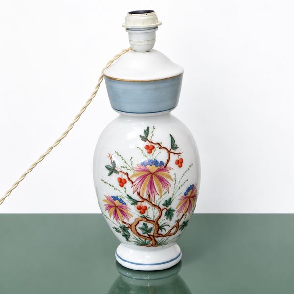 White ceramic lamp with floral decorations on the front