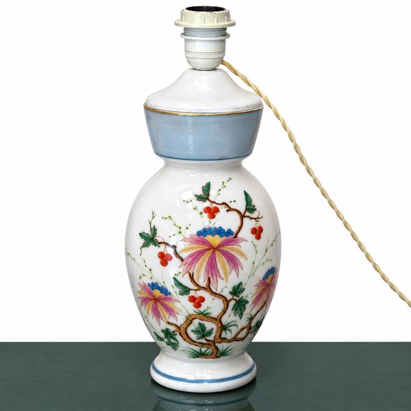 White ceramic lamp with floral decorations on the front