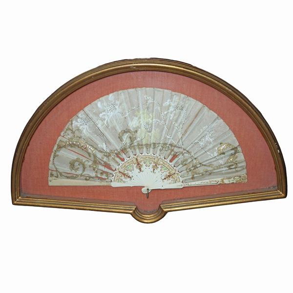 Fan with floral decorations in a golden case