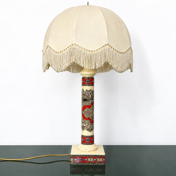 Ceramic table lamp with geometric and ethnic decorative motifs on a beige background