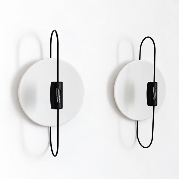 Luciano Pagani  per ArteLuce - Coppia di lampade da parete o da soffitto modello Spilla caratterizzate da una struttura a forma di spilla da balia nera che attraversa un disco riflettente bianco