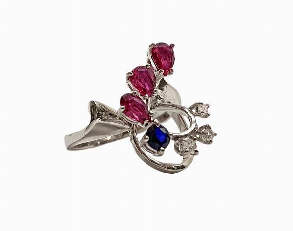 White gold ring with three rubies, one sapphire blue and bright 3