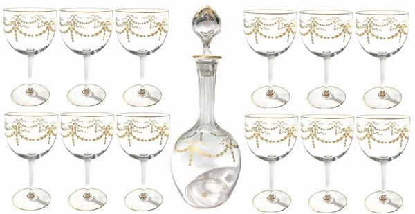 Servivio of crystal wine glasses consists of one bottle with gold color lace, 12 glasses with lace in gold