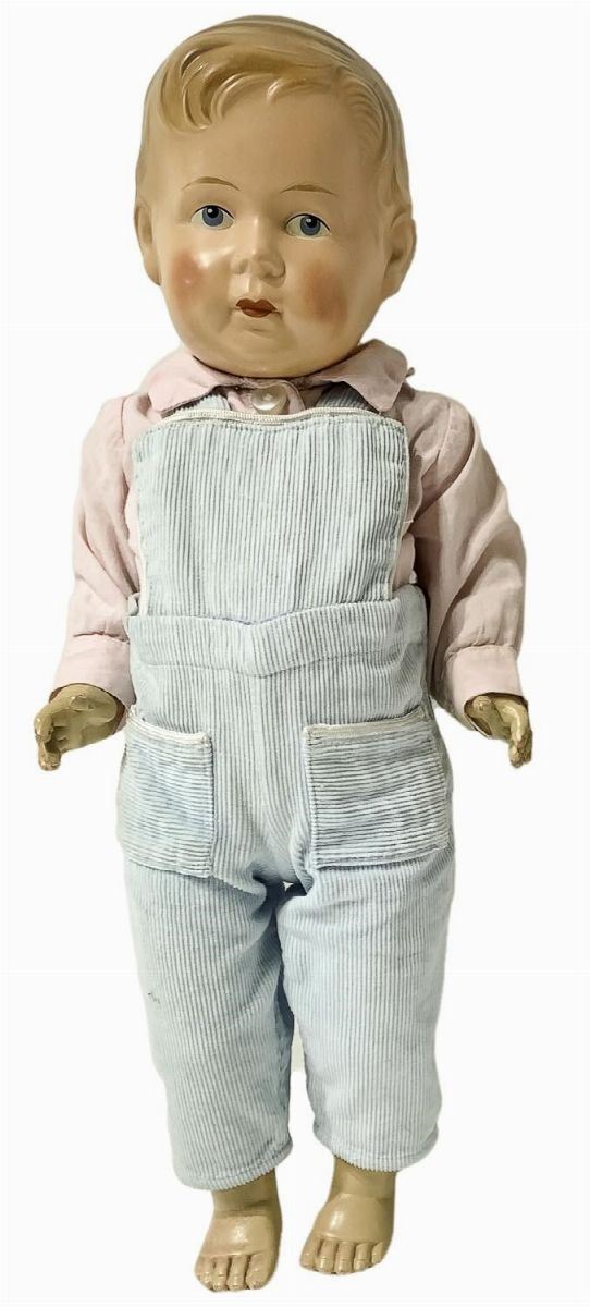 Celluloid doll, eyes fixed, movable limbs, 40s. Original clothing, still intact