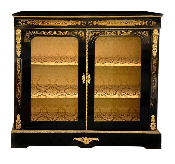 Showcase low ebonized black wood and golden brass inlays and applied bronzes, two doors glass, interior with two shelves. Napoleon III, late nineteenth century. H cm 115. Cm 120x33