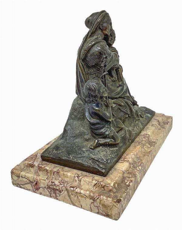 Bronze depicting Madonna and Child with Saint John on marble base. Early twentieth century. H 15 cm Base cm 19x10,5