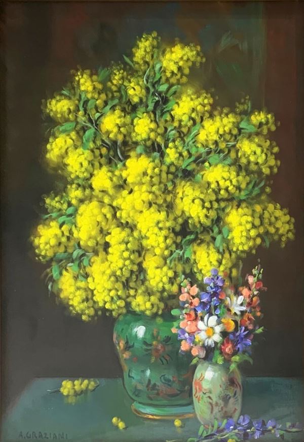 Dipinto ad olio su tela raffigurante “Mimose con violette”, firmato in basso a sinistra A. Graziani. Alfio Paolo Graziani (Roncoferraro 1900-Gavirate 1981). Cm 50x70, in cornice cm 94x73