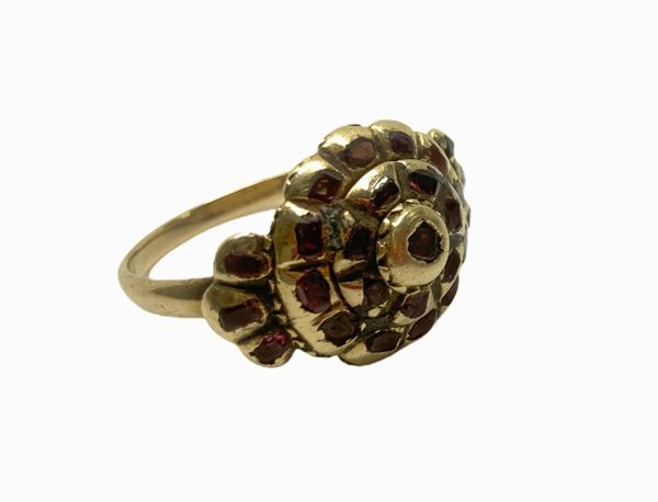 Ring low titer with rosette with slivers of rubies (missing one)