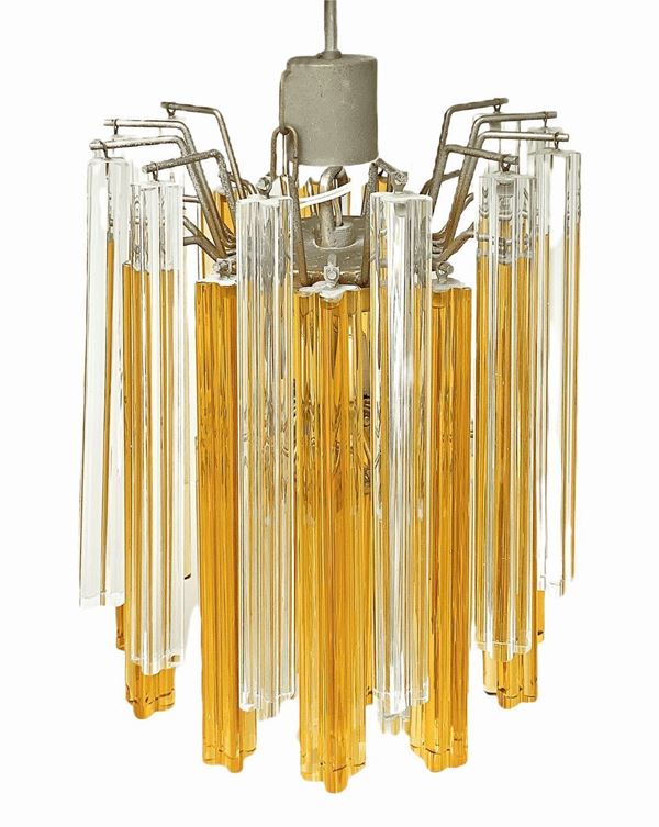 Lampadario in vetro di Murano a canne quadrilobate trasparente e nei toni del giallo. Prima met&agrave; XX secolo. Cm 140 di altezza. Una canna sostituita.