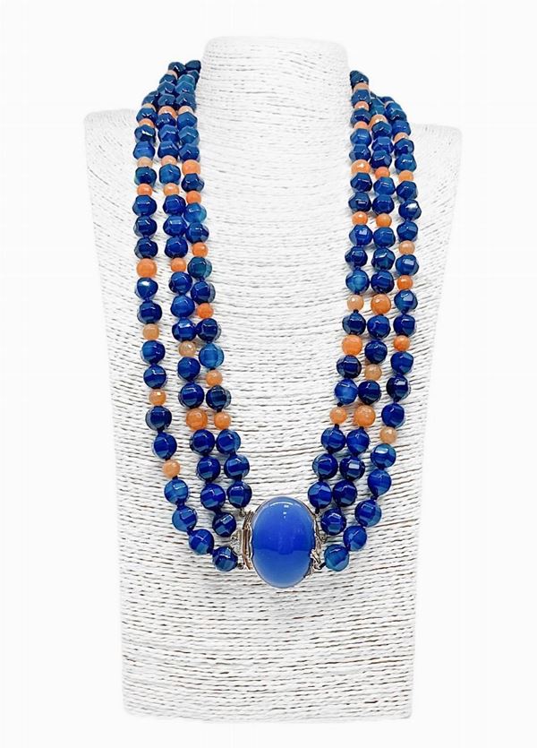 Collana in AGATA BLU sfaccettata mm 12, alternata ad EOSITE sfaccettata mm 6/8. (avventurina arancio). Chiusura in argento laccato Oro con centrale ... 