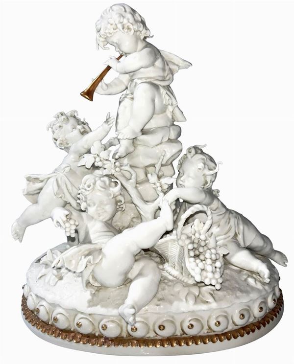Porcelain figurine in white color at the base with lace in gold color, a game of cherubs. H 23 cm. Base 20x13.5 cm. Dated 1961. Signed by Gellè. Small chips.
