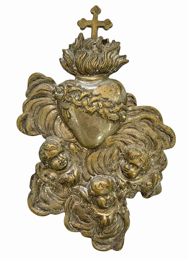 Heart-shaped ex voto partly in solid vermeil with zephyr heads