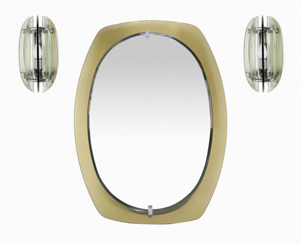 Produzione Veca, specchiera e applique. anni '60,in vetro molato nei toni del bronzo, dettagli in metallo cromato. Specchio ovale cm 80x60. Applique ... 