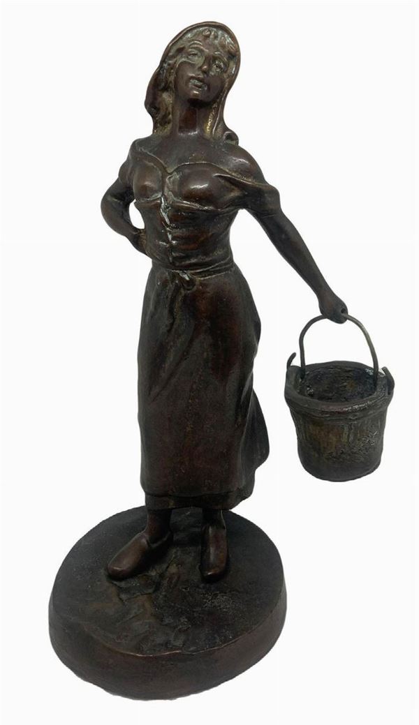 Bronzo patinato bruno raffigurante donna con secchio, fine XIX secolo. H cm 28.


