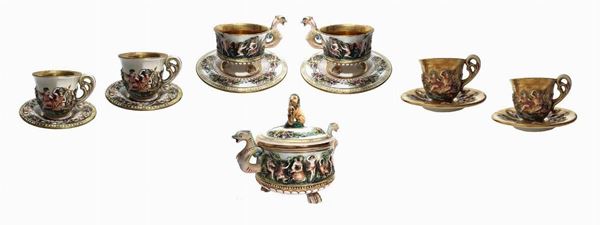 set from you and porcelain coffee, brand Capodimonte 2226. Consisting of sugar (H cm14x15), 2 cups of tea (7 cm H, diam. 8 cm), 2 coffee mugs (H 6 cm, diam. 7 cm) 2 coffee mugs (6.5 cm H, diam. 7 cm). Decoration with figures in high relief and genre scenes.
