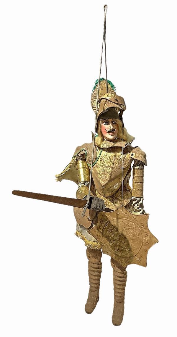 Sicilian marionette Pupo, large-size, XX century. With metal armor embossed and gilded and fabric. H cm 85. Present signs of rust.